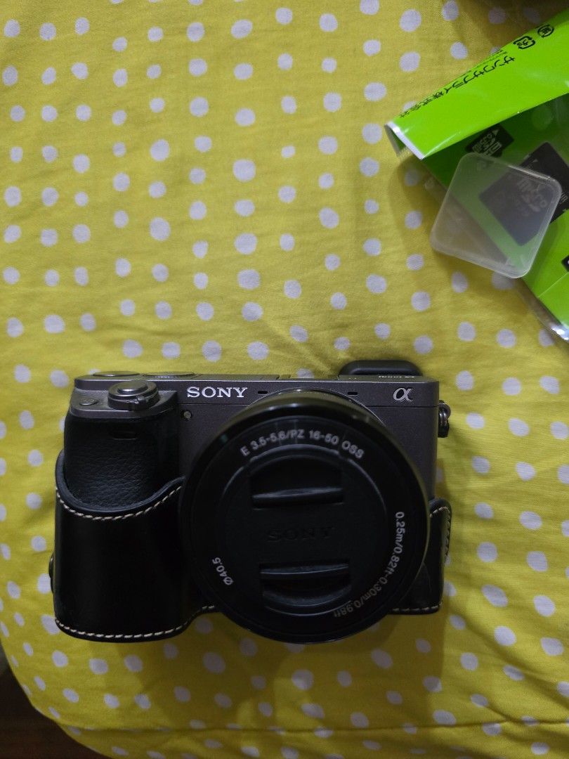 Sony Alpha a6000 Mirrorless Camera with 16-50mm Lens (Category: Cameras) located in Quezon City. Submitted by mmmabbie (Listing ID 1464241921, Image 1). Description: - Sony Alpha a6000 camera - Includes 16-50mm OSS lens - Includes extra battery - Includes E35mm lens - Comes with black leather case - Includes charger - Includes camera bag grey - Black Kangol camera bag - Multiple SD card cases - Includes cleaning accessory - Included SD card bag -