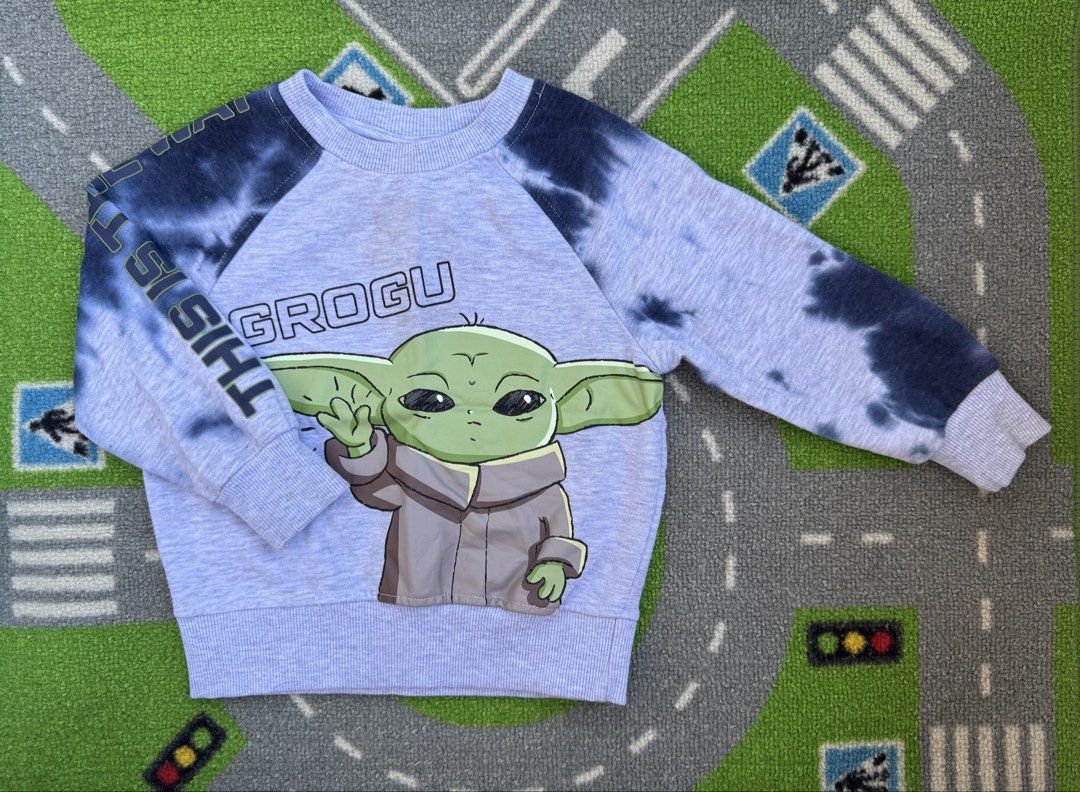Star Wars Grogu Tie-Dye Sweatshirt Jacket (Category: Babies & Kids Fashion) located in Rizal. Submitted by preloovved (Listing ID 1464250462, Image 1). Description: - Preloved, 2yo - Cute light purple sweatshirt - Tie-dye pattern on sleeves - Features Grogu from Star Wars on the front - Sleeve text: 'This is' - Soft and comfy material - Ideal for young Star Wars fans Meet-up only in GB1 San Mateo, Rizal Shipping fee c/o buyer. Tres Marias or J&T 