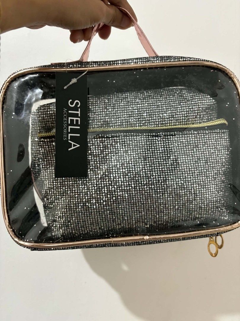 Stella Accessories Glitter Cosmetic Bag Set (Category: Purses & Pouches) located in Caloocan City. Submitted by vcsmartine20166 (Listing ID 1464254275, Image 1). Description: - Three-piece glitter cosmetic bag set - Large clear bag with pink handle and rose gold trim - Includes two smaller glitter pouches: one flat, one rounded - Ideal for organizing makeup and toiletries - Features a sparkly and eye-catching design.