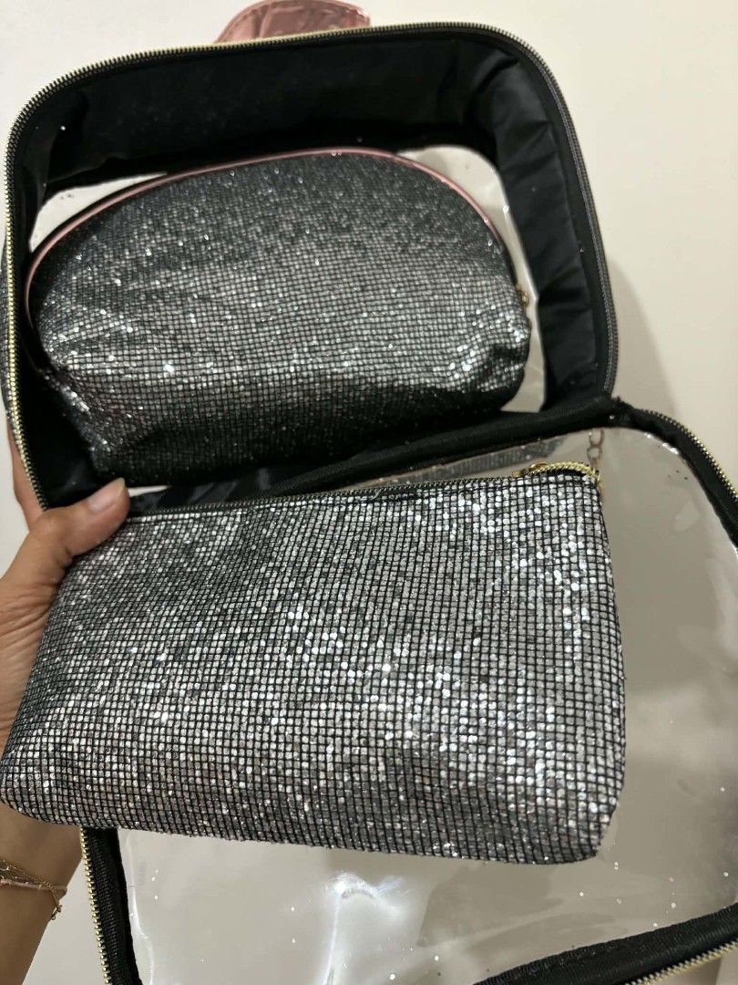Stella Accessories Glitter Cosmetic Bag Set (Category: Purses & Pouches) located in Caloocan City. Submitted by vcsmartine20166 (Listing ID 1464254275, Image 3). Description: - Three-piece glitter cosmetic bag set - Large clear bag with pink handle and rose gold trim - Includes two smaller glitter pouches: one flat, one rounded - Ideal for organizing makeup and toiletries - Features a sparkly and eye-catching design.