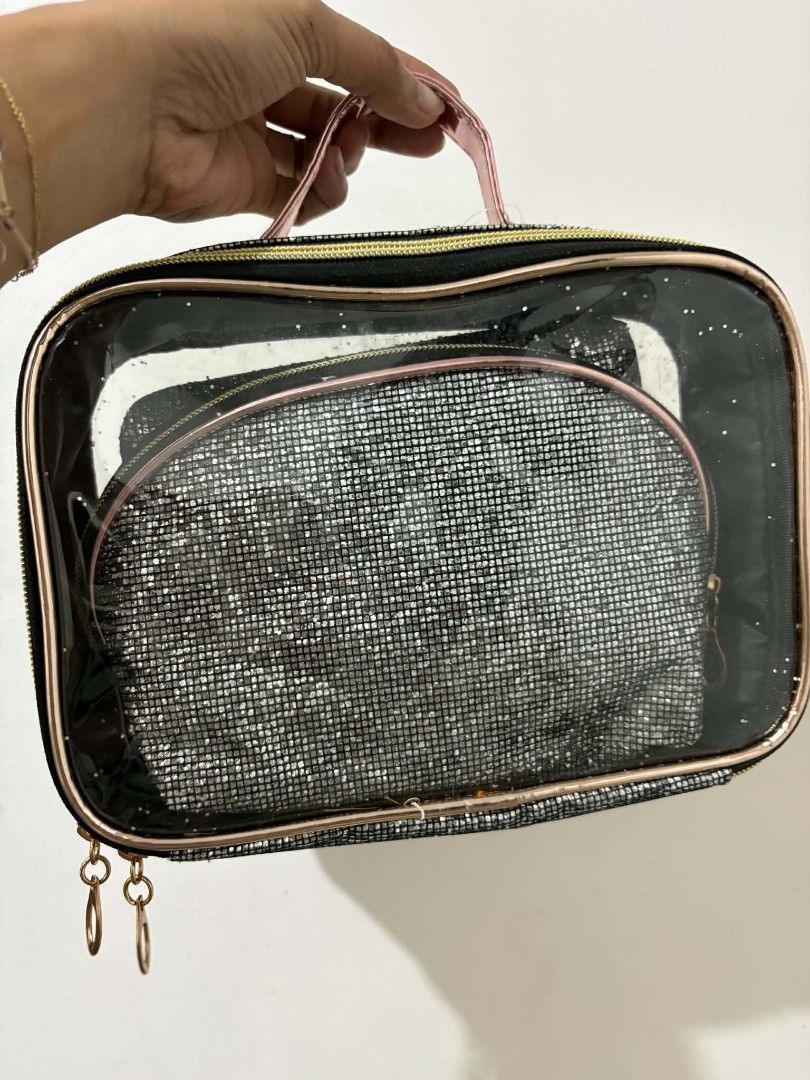 Stella Accessories Glitter Cosmetic Bag Set (Category: Purses & Pouches) located in Caloocan City. Submitted by vcsmartine20166 (Listing ID 1464254275, Image 2). Description: - Three-piece glitter cosmetic bag set - Large clear bag with pink handle and rose gold trim - Includes two smaller glitter pouches: one flat, one rounded - Ideal for organizing makeup and toiletries - Features a sparkly and eye-catching design.
