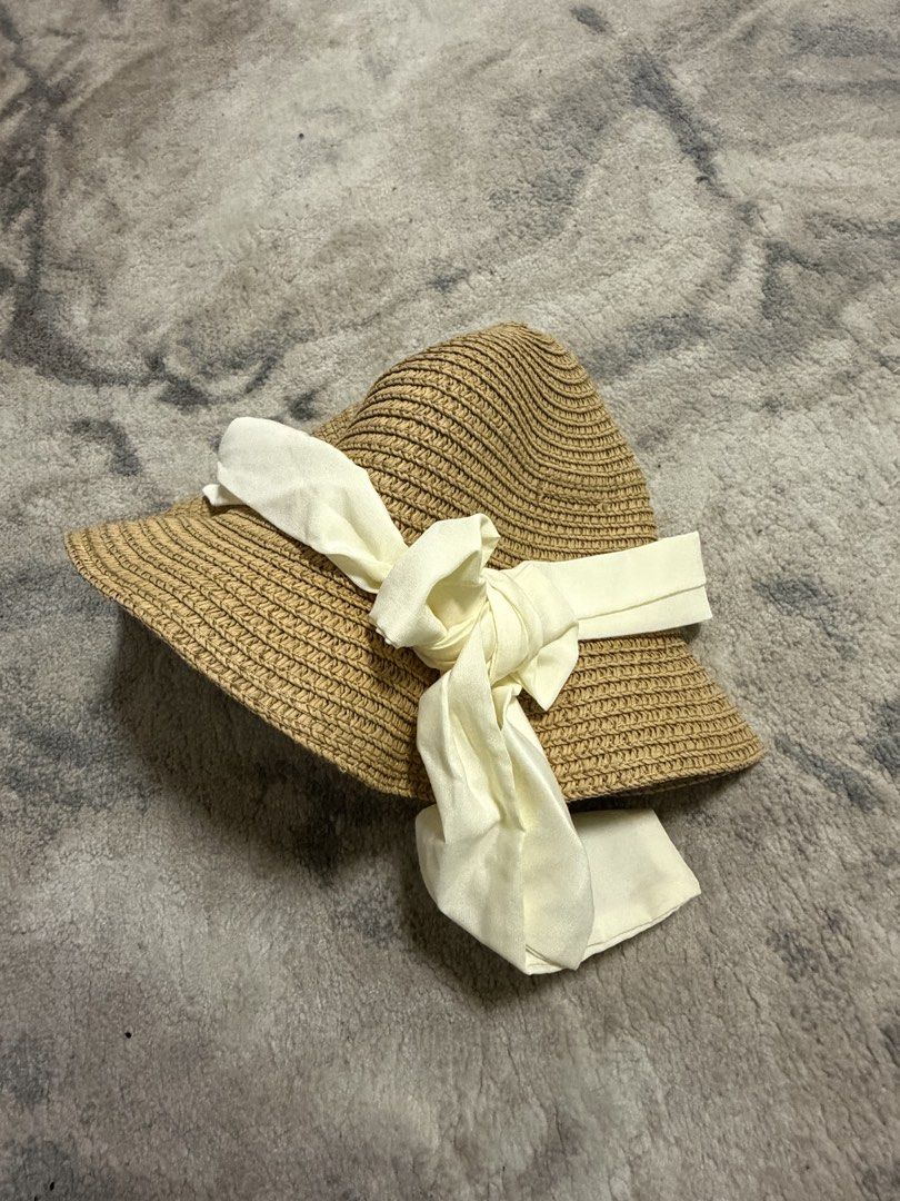Straw Hat with Ribbon Detail (Category: Babies & Kids Fashion) located in Manila. Submitted by e.louise (Listing ID 1464332749, Image 2). Description: - Cute straw hat perfect for sunny days. - Wide brim offers excellent sun protection. - Adorned with a cream-colored ribbon and bow. - Ideal for beach trips or everyday casual wear. - Lightweight and easy to pack for travel..