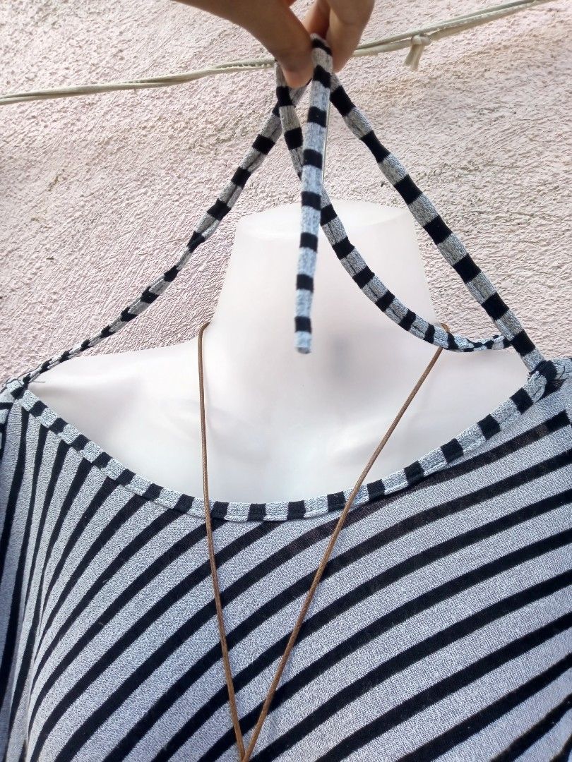 Striped Off-Shoulder Top with Halter Neck Tie (Category: Blouses) located in Placer. Submitted by whimsythrifts (Listing ID 1464205120, Image 3). Description: - Stylish black and white striped top - Trendy off-shoulder design with halter neck tie - Comfortable three-quarter sleeves - Fabric with a slight sheen - Ideal for casual outings.
