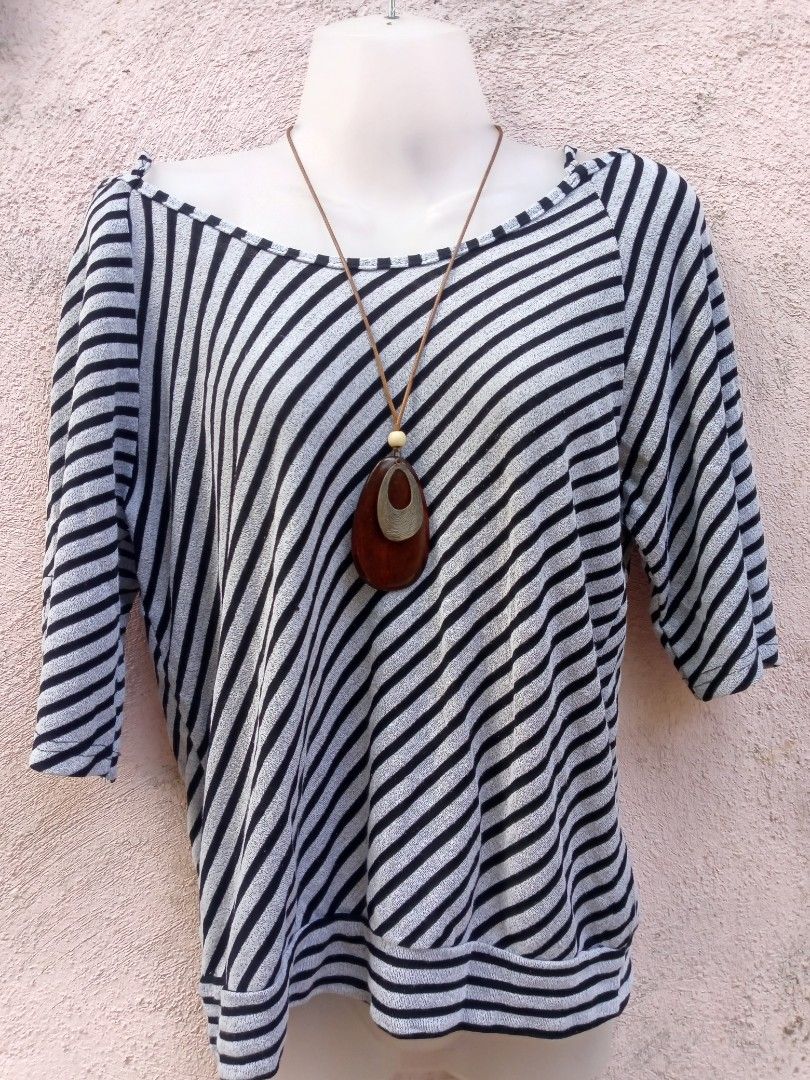 Striped Off-Shoulder Top with Halter Neck Tie (Category: Blouses) located in Placer. Submitted by whimsythrifts (Listing ID 1464205120, Image 2). Description: - Stylish black and white striped top - Trendy off-shoulder design with halter neck tie - Comfortable three-quarter sleeves - Fabric with a slight sheen - Ideal for casual outings.