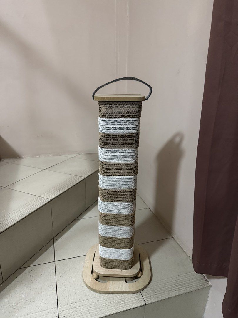 Tall Cardboard Cat Scratching Post with Toy Ball (Category: Homes & Other Pet Accessories) located in Manila. Submitted by barneyss (Listing ID 1464235394, Image 2). Description: - Tall scratching post for your cat - Made with durable cardboard - Features a fun toy ball attached to the base - Easy to assemble and move around - Your cat will love this! Still in good condition. RFS: cat doesn't use it at all. .