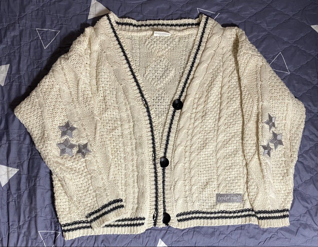 Taylor Swift Folklore Cardigan (Category: Coats, Jackets and Outerwear) located in Manila. Submitted by silverhorse.07f3d0 (Listing ID 1464238774, Image 1). Description: Original Taylor Swift Merch - Cream colored knit cardigan - Black trim detail - Embroidered stars on sleeves - Small 'taylor swift' tag on hem - Cable knit detailing throughout - Button front closure.