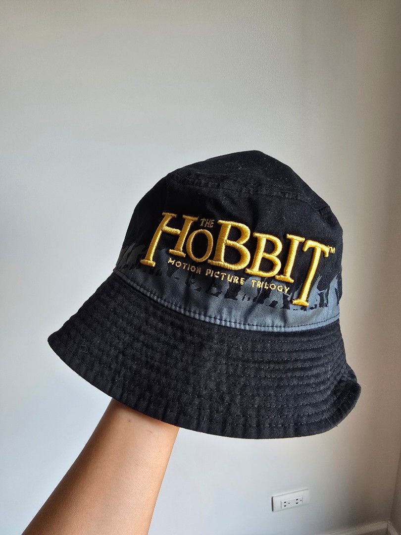 The Hobbit Motion Picture Trilogy Bucket Hat (Category: Caps & Hats) located in Paranaque City. Submitted by incognitopawikan (Listing ID 1464157051, Image 1). Description: - Bought in Hobbiton in New Zealand - Black bucket hat from The Hobbit Motion Picture Trilogy - Features embroidered text and graphics - Great for fans of the movies - One size fits most - A cool accessory for any outfit.