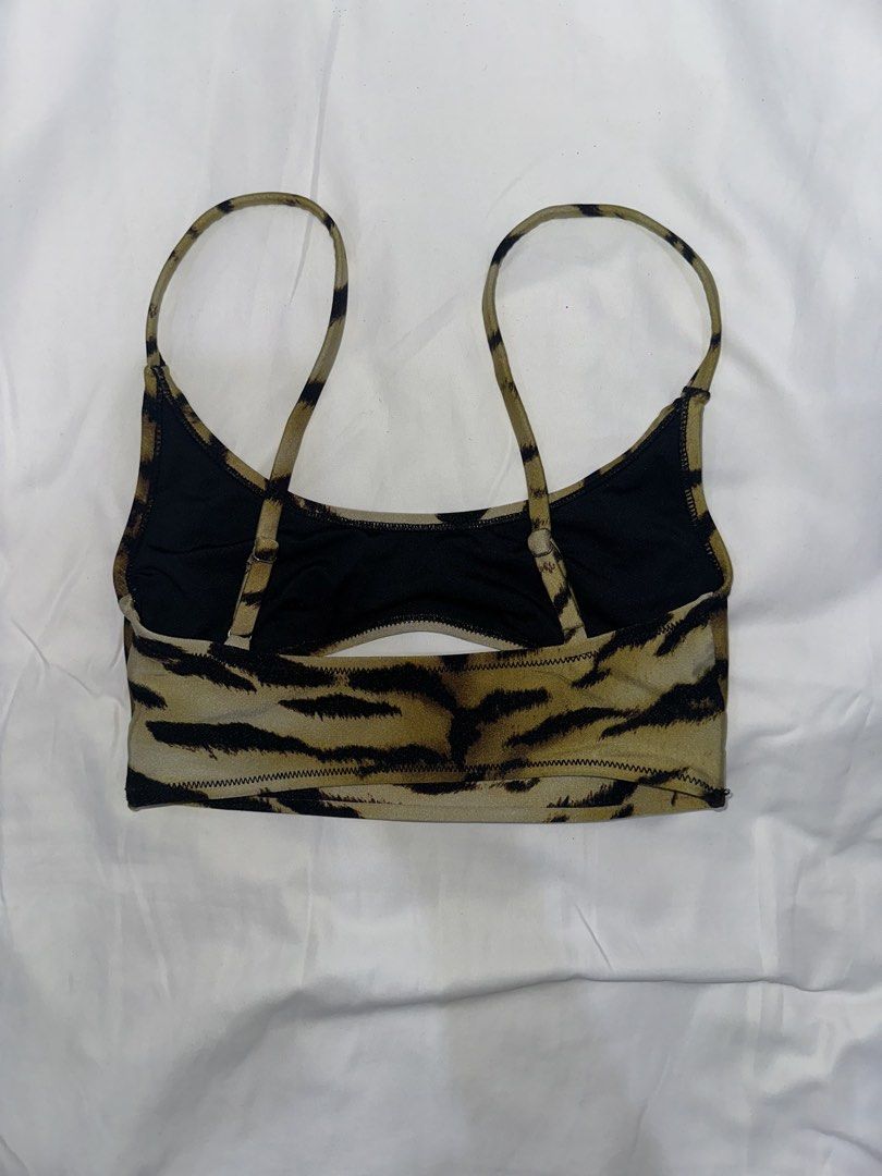 Tiger Print swimsuit top (Category: Activewear) located in Cainta. Submitted by buy.preloved (Listing ID 1464249019, Image 2). Description: - Trendy tiger print swimsuit top - Thin, adjustable straps with clasp closure at the back - Stylish front cut-out detail - Comfortable black lining inside - Versatile for workouts or as a fashion layering piece.