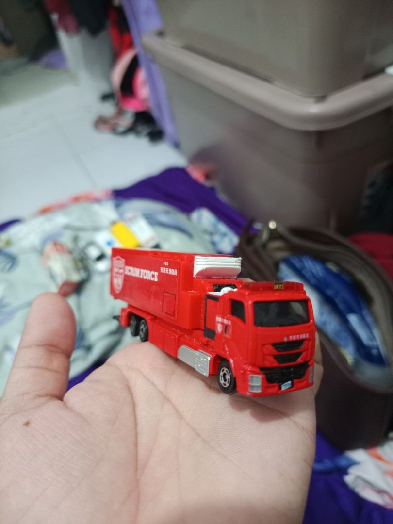 Tomica Scrum Force Fire Truck Toy (Category: Vehicle & Diecast Models) located in Manila. Submitted by warmcrystal_269010 (Listing ID 1464196061, Image 2). Description: - Red Tomica "Scrum Force" fire truck toy - Made in Vietnam - Back compartment opens - Wheels roll smoothly - Ideal for collectors or kids who love emergency vehicles - Great addition to any toy collection.
