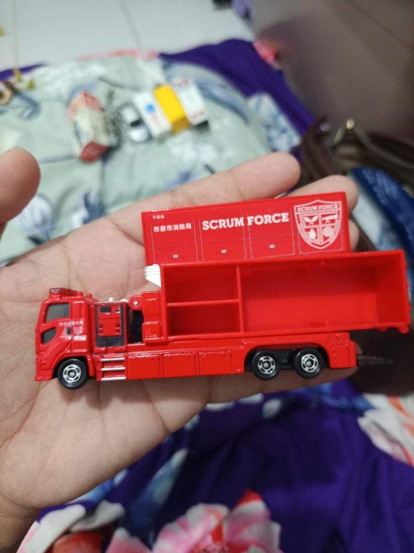Tomica Scrum Force Fire Truck Toy (Category: Vehicle & Diecast Models) located in Manila. Submitted by warmcrystal_269010 (Listing ID 1464196061, Image 3). Description: - Red Tomica "Scrum Force" fire truck toy - Made in Vietnam - Back compartment opens - Wheels roll smoothly - Ideal for collectors or kids who love emergency vehicles - Great addition to any toy collection.
