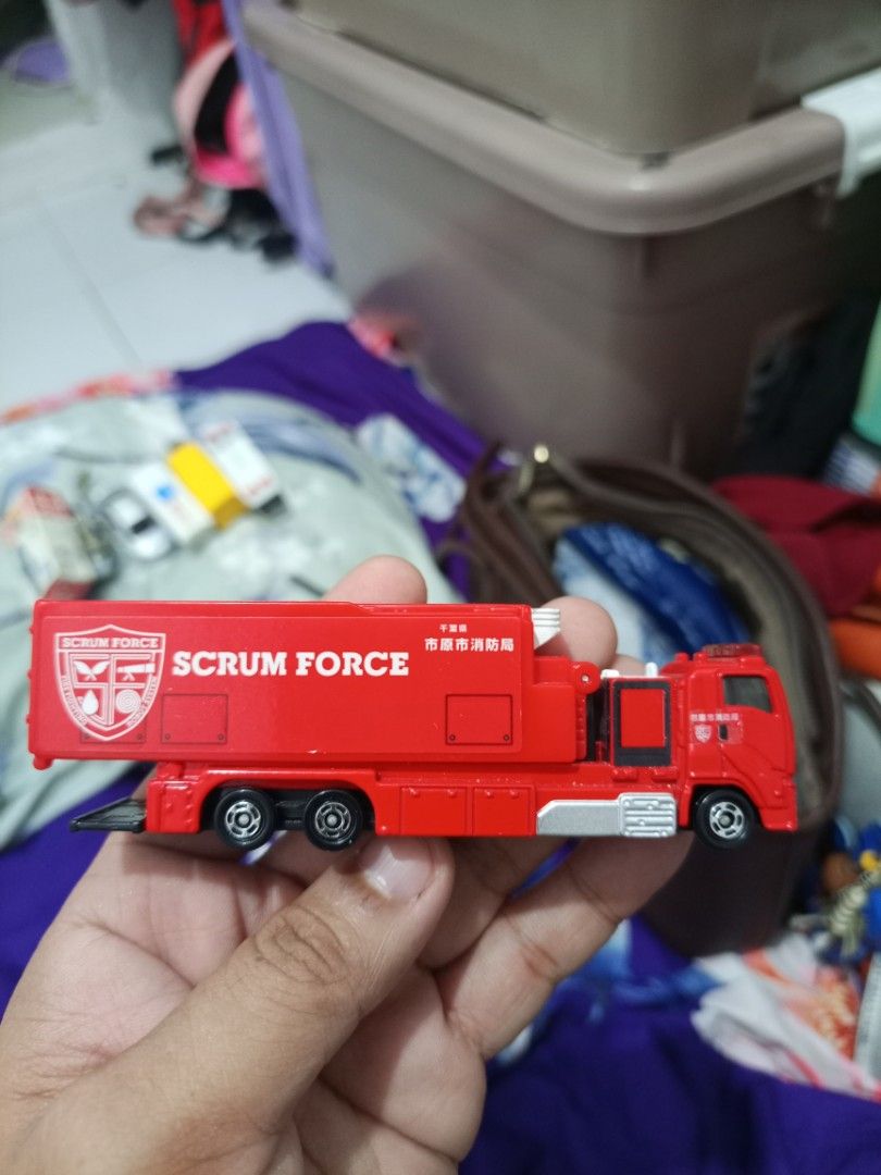 Tomica Scrum Force Fire Truck Toy (Category: Vehicle & Diecast Models) located in Manila. Submitted by warmcrystal_269010 (Listing ID 1464196061, Image 1). Description: - Red Tomica "Scrum Force" fire truck toy - Made in Vietnam - Back compartment opens - Wheels roll smoothly - Ideal for collectors or kids who love emergency vehicles - Great addition to any toy collection.