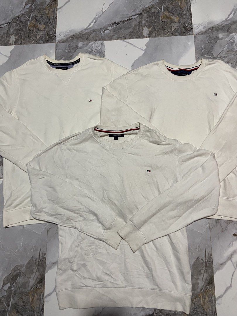 Tommy Hilfiger White Sweatshirts Bundle (Sizes M, L) (Category: Hoodies) located in Manila. Submitted by kentjohnz. (Listing ID 1464298398, Image 1). Description: - Bundle deal: 3 Tommy Hilfiger white sweatshirts - Sizes available: 2 x Medium (M), 1 x Large (L) - Features the iconic Tommy Hilfiger logo - Ideal for everyday casual wear.