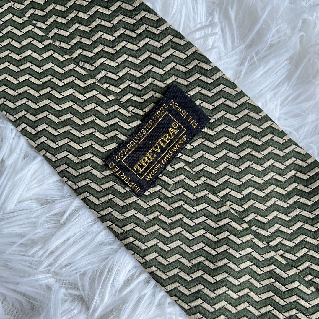 Trevira 100% Polyester Geometric Pattern Tie (Category: Ties) located in Cuyapo. Submitted by Ashtyn.Pre.Loved (Listing ID 1464202919, Image 2). Description: - Stylish green and beige geometric pattern tie. - Made from 100% polyester. - Imported item. - Adds a classic touch to any outfit. - Versatile for various occasions..