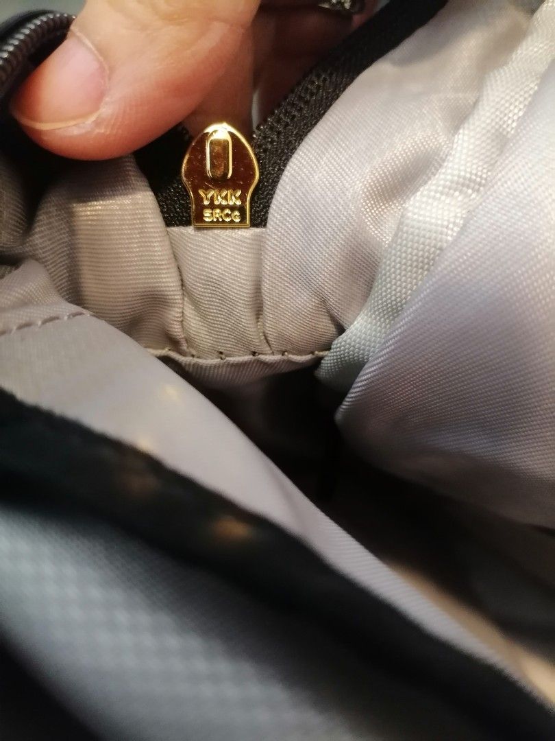 Tumi Black Nylon Backpack Gold Hardware (Category: Backpacks) located in Digos. Submitted by crodualady82694 (Listing ID 1464153673, Image 3). Description: - Classic black Tumi backpack - Durable nylon material - Elegant gold-tone zippers and hardware - Multiple interior and exterior pockets for organization - Light grey fabric lining - Smooth YKK zippers - Perfect for daily use, work, or travel.