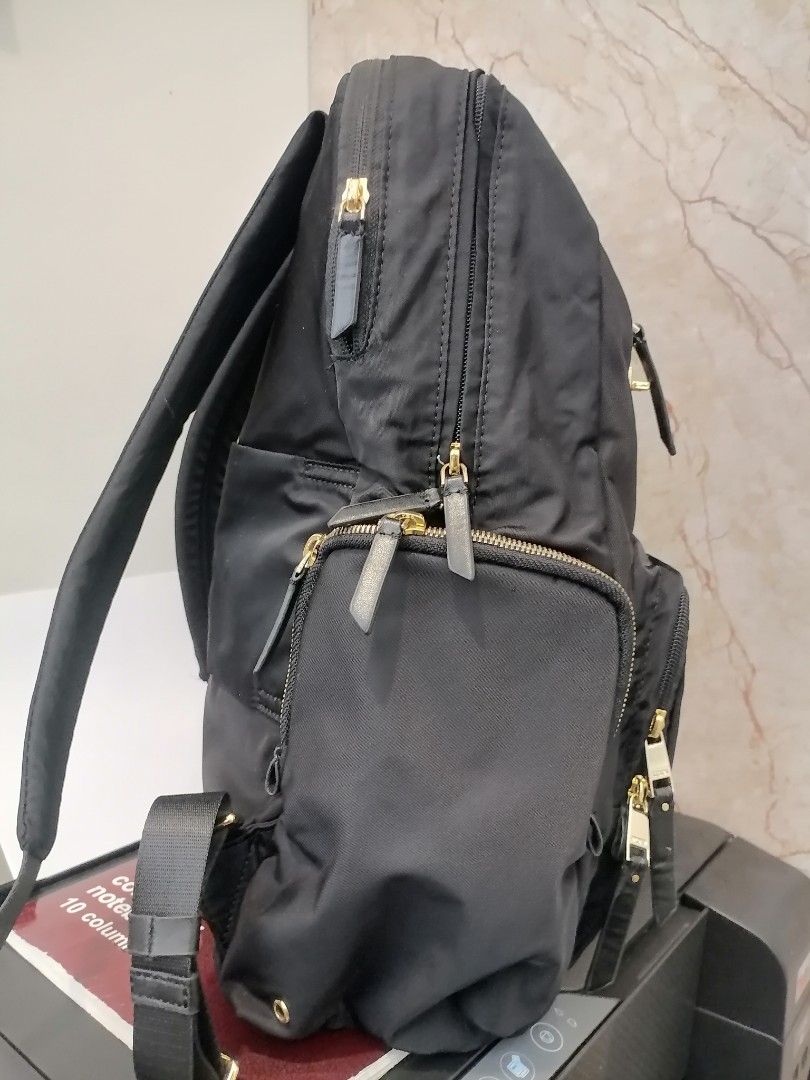 Tumi Black Nylon Backpack Gold Hardware (Category: Backpacks) located in Digos. Submitted by crodualady82694 (Listing ID 1464153673, Image 2). Description: - Classic black Tumi backpack - Durable nylon material - Elegant gold-tone zippers and hardware - Multiple interior and exterior pockets for organization - Light grey fabric lining - Smooth YKK zippers - Perfect for daily use, work, or travel.