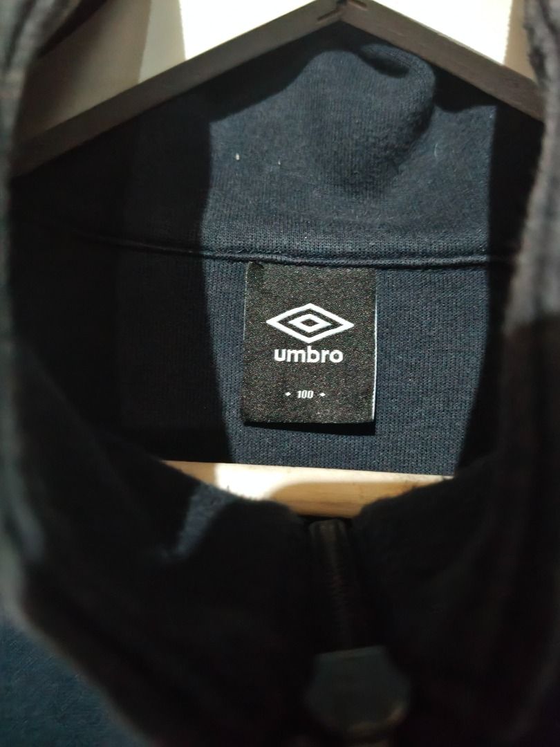 Umbro Black & White 1/4 Zip Sweatshirt (Category: Coats, Jackets and Outerwear) located in Cotabato. Submitted by grandwolf-98e8 (Listing ID 1464277521, Image 3). Description: - Brand: Umbro - Color: Black with white panel details - Features: 1/4 zip neck, ribbed cuffs and hem - Style: Casual wear or sports.