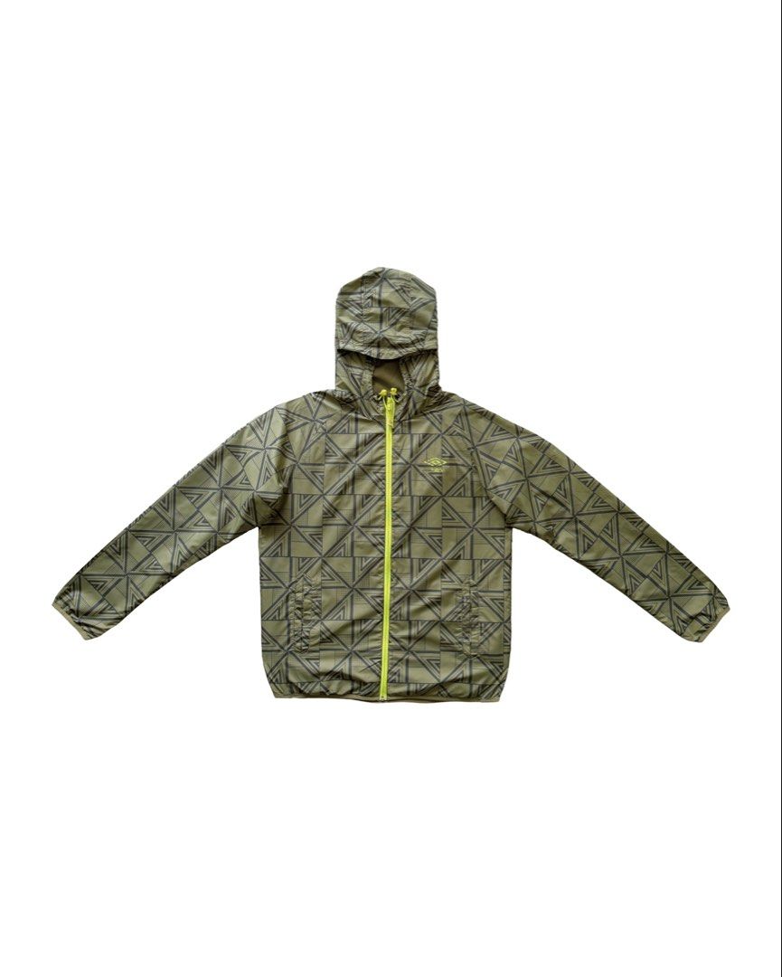Umbro Packable Windbreaker (Category: Coats, Jackets and Outerwear) located in Manila. Submitted by morf_sply (Listing ID 1464304308, Image 1). Description: High collar with adjustable hood and visor made with weatherproof outer layer protection. Logo on the chest. Long sleeves with elasticated cuffs. Elasticated hem at the sides. Welt pockets. Medium on tag. Shoulder Width 18 in Pit to Pit 22 in Length 26 in Sleeves 25 in.
