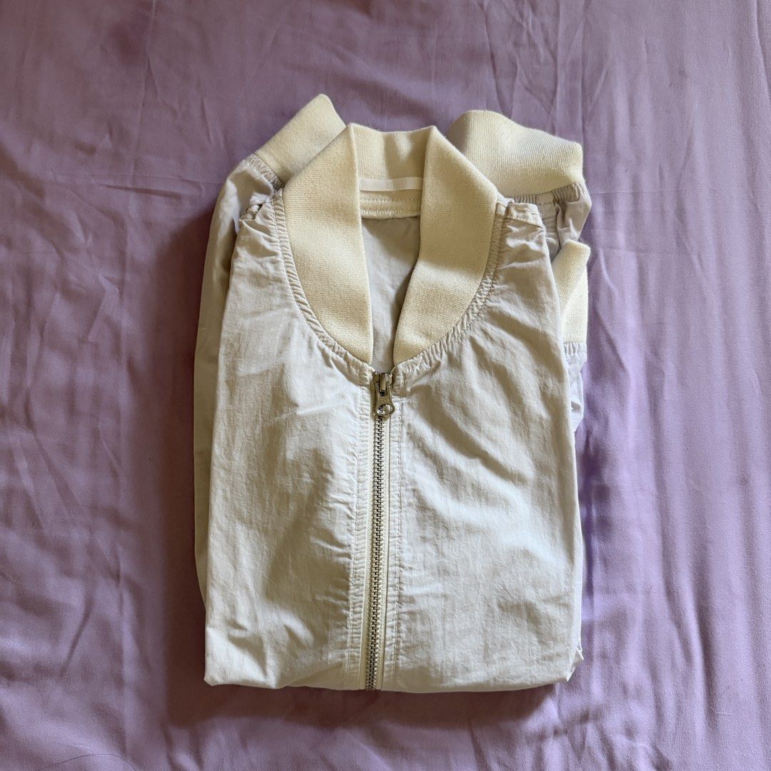 Uniqlo Light Bomber Jacket (Category: Coats, Jackets and Outerwear) located in Manila. Submitted by dyjamie (Listing ID 1464218224, Image 2). Description: - Lightweight Uniqlo bomber jacket - Light grey color - Cream ribbed collar, cuffs, and hem - Full zip front - Ideal for layering or light outerwear - Easy to pack and wear.