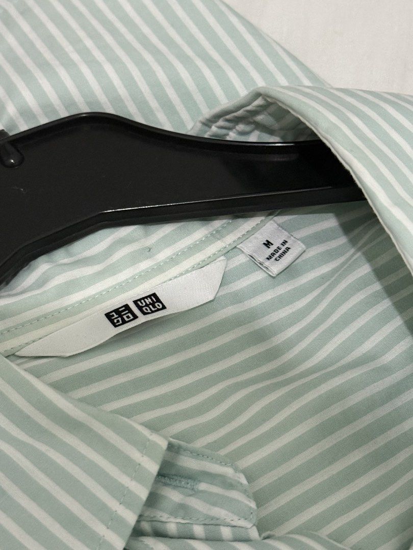 Uniqlo Striped Button-Up Shirt Size M (Category: Tshirts & Polo Shirts ) located in Mandaluyong City. Submitted by trovebya (Listing ID 1464236047, Image 3). Description: - Uniqlo Button-Up Shirt - Color: Light Green with White Pinstripes - Size: Medium (M) - Style: Long sleeves, collared - Versatile: Great for casual outfits or as a layering piece - Easy to style.