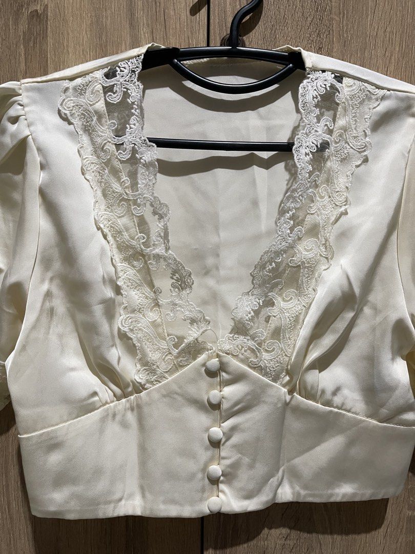 V Neck White Lace Trimmed Cropped Top (Category: Sleeveless) located in Manila. Submitted by preloveditems_jem (Listing ID 1464301699, Image 3). Description: Chic white cropped top with V-neck, button-up front, and puff sleeves. Features delicate lace details on neckline and sleeves..