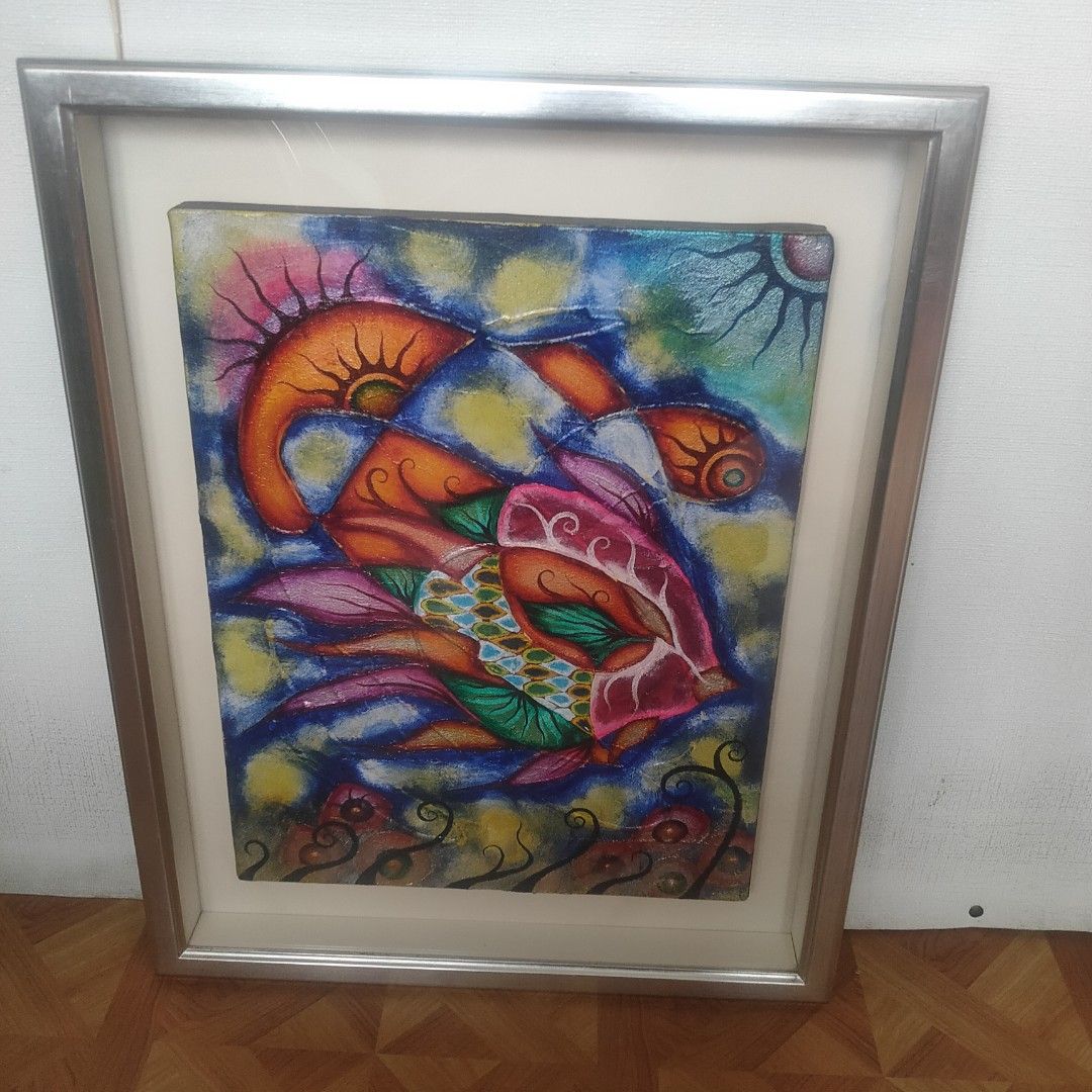 Vibrant Fish Artwork Framed Painting 2006 (Category: Frames & Pictures) located in Dasmarinas. Submitted by amara1022 (Listing ID 1464216540, Image 1). Description: - Colorful framed artwork featuring a stylized fish. - Textured finish with vibrant orange, pink, green, and blue hues. - Encased in a sleek silver-toned metal frame. - Signed and dated on the back: '2006.8.9'. - Perfect for adding a lively splash of color to your walls. L 21cm w 17cm