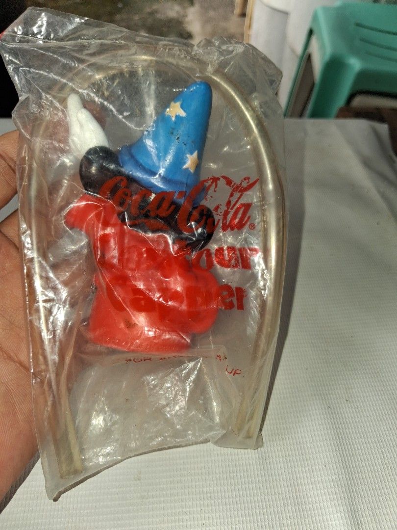 Vintage Mickey Mouse Wizard Toy Figure in Packaging (Category: Designer & Blind Box Toys) located in Manila. Submitted by marcas022798212 (Listing ID 1464151510, Image 2). Description: - Vintage Mickey Mouse Wizard Toy Figure - Dressed as a wizard with blue starry hat and red robe - Still in original plastic packaging - Includes original metal hanger - Coca-Cola logo visible on packaging - Great collectible for Disney fans.