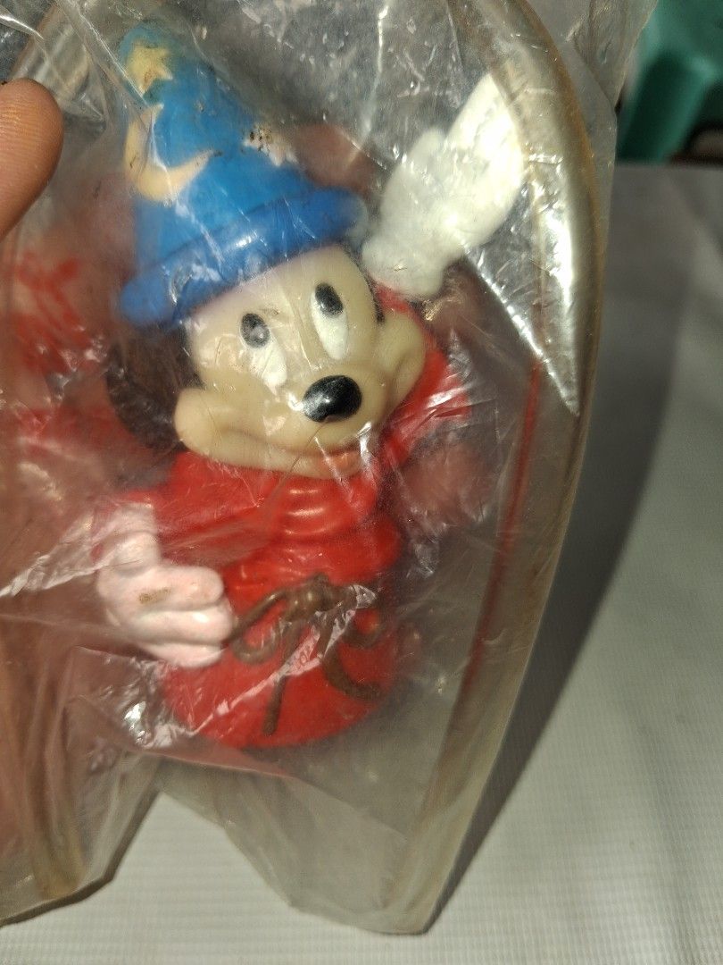Vintage Mickey Mouse Wizard Toy Figure in Packaging (Category: Designer & Blind Box Toys) located in Manila. Submitted by marcas022798212 (Listing ID 1464151510, Image 1). Description: - Vintage Mickey Mouse Wizard Toy Figure - Dressed as a wizard with blue starry hat and red robe - Still in original plastic packaging - Includes original metal hanger - Coca-Cola logo visible on packaging - Great collectible for Disney fans.