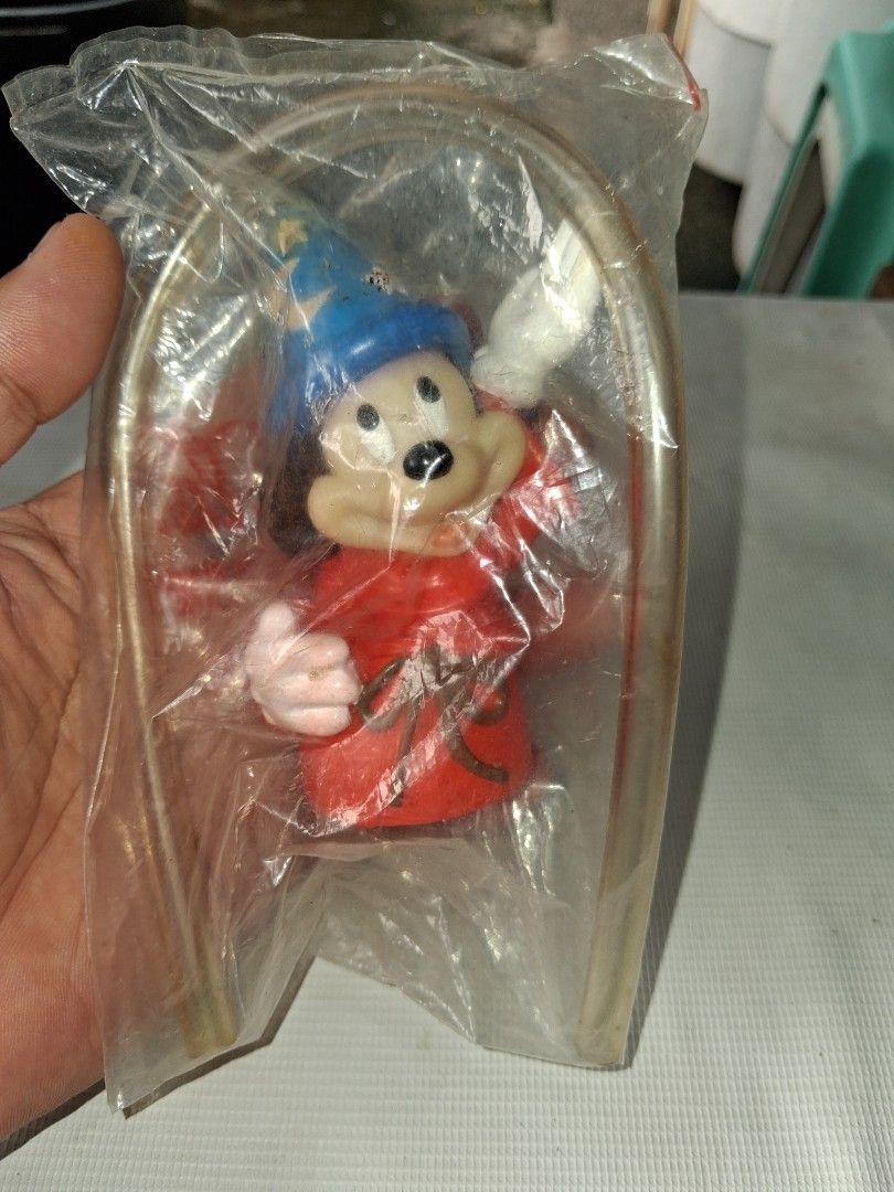 Vintage Mickey Mouse Wizard Toy Figure in Packaging (Category: Designer & Blind Box Toys) located in Manila. Submitted by marcas022798212 (Listing ID 1464151510, Image 3). Description: - Vintage Mickey Mouse Wizard Toy Figure - Dressed as a wizard with blue starry hat and red robe - Still in original plastic packaging - Includes original metal hanger - Coca-Cola logo visible on packaging - Great collectible for Disney fans.