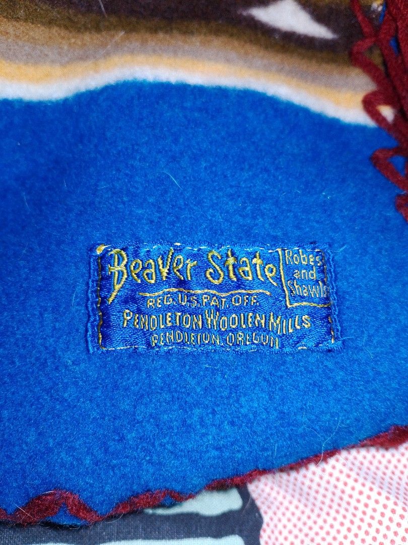 Vintage pendleton beaver state wool shawl blancket (Category: Luxury Apparel) located in Manila. Submitted by takeroshc143 (Listing ID 1464163555, Image 1). Description: Selling a beautiful and authentic Vintage Pendleton Woolen Mills "Beaver State" Shawl Blanket. This piece features a vibrant blue base with striking Native American-inspired geometric diamond/chevron stripes in orange, green, and brown.Size: Approx. 60" x 62" (Adult Square Shawl 