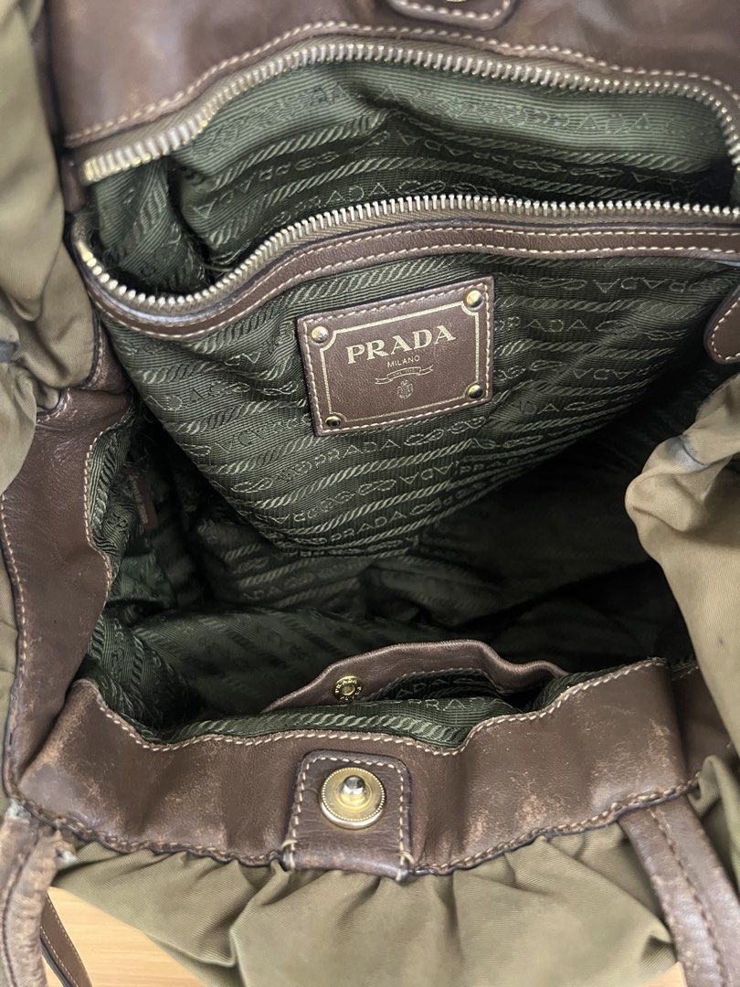 Vintage Prada Nylon & Leather Drawstring Hobo Bag Olive Green (Category: Luxury Bags & Wallets) located in Manila. Submitted by pearlt455 (Listing ID 1464244183, Image 3). Description: - Authentic Vintage Prada Tessuto Nylon Drawstring Tote bag - Color: Olive green nylon with brown leather accents - Closure: Drawstring - Condition: Well-Used - Leather straps show some wear, faint marks on exterior nylon, interior lining is clean (please see photo