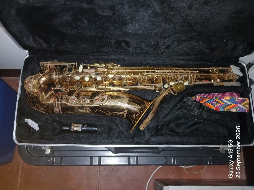Vintage Saxophone with Case and Accessories (Category: Musical Instruments) located in Caloocan City. Submitted by joshsison1109 (Listing ID 1464149487, Image 1). Description: - Vintage saxophone - Includes hard case with black lining - Comes with mouthpiece and colorful strap - Ideal for collectors or musicians.