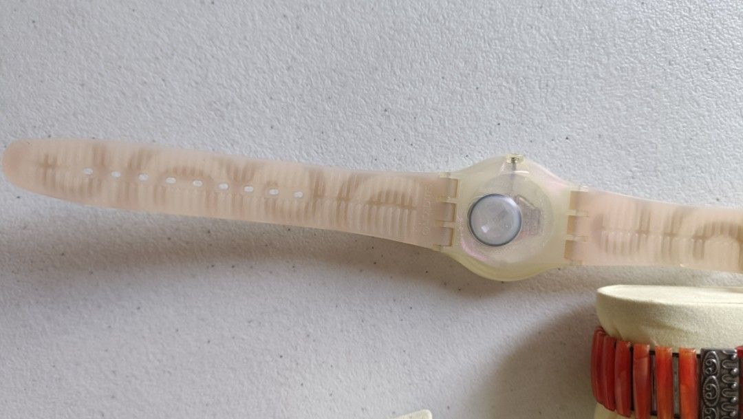 Vintage Swatch Pearly Tears 38mm (Category: Luxury Watches) located in Quezon City. Submitted by unusual_knicknacks (Listing ID 1464264471, Image 3). Description: - Swatch watch with a light pink pearlescent face - Translucent pink strap with repeating silver swirl pattern - Clear plastic buckle closure - A fun and stylish accessory.