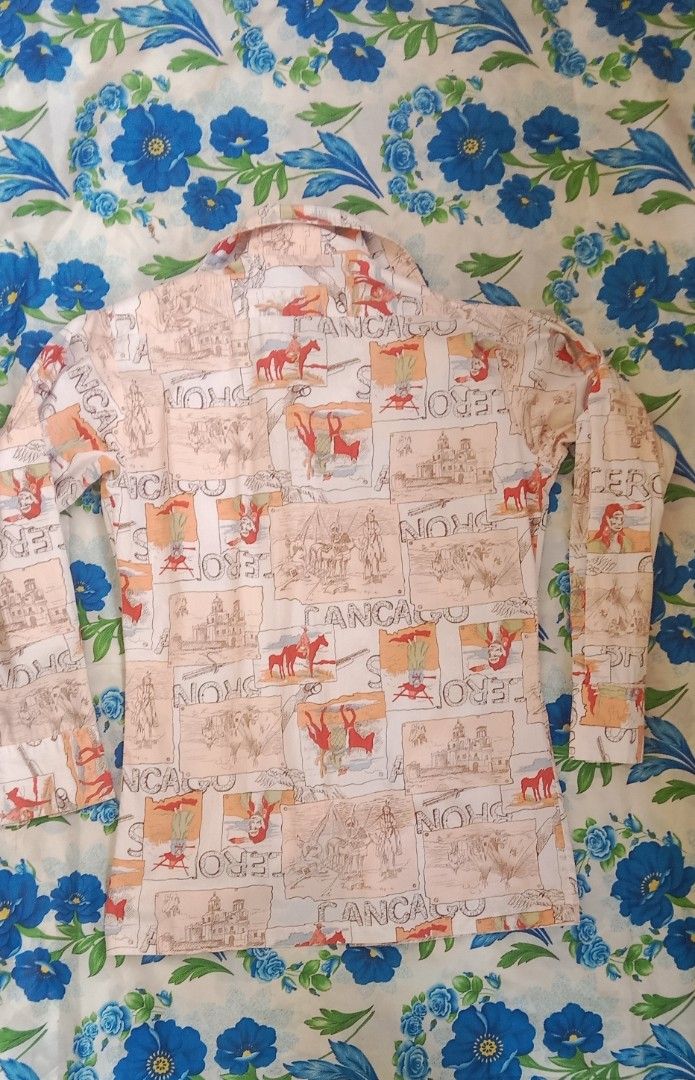 Vintage Western Print Button-Up Shirt (Category: Tshirts & Polo Shirts ) located in Koronadal. Submitted by gifts.thrifts (Listing ID 1464160166, Image 2). Description: - Vintage western-themed shirt - Features cowboys, horses, and buildings print - Long sleeves with button cuffs - 100% cotton fabric - Measurements: Pit to pit approx 18 inches, length approx 25 inches - Perfect for a unique retro look.