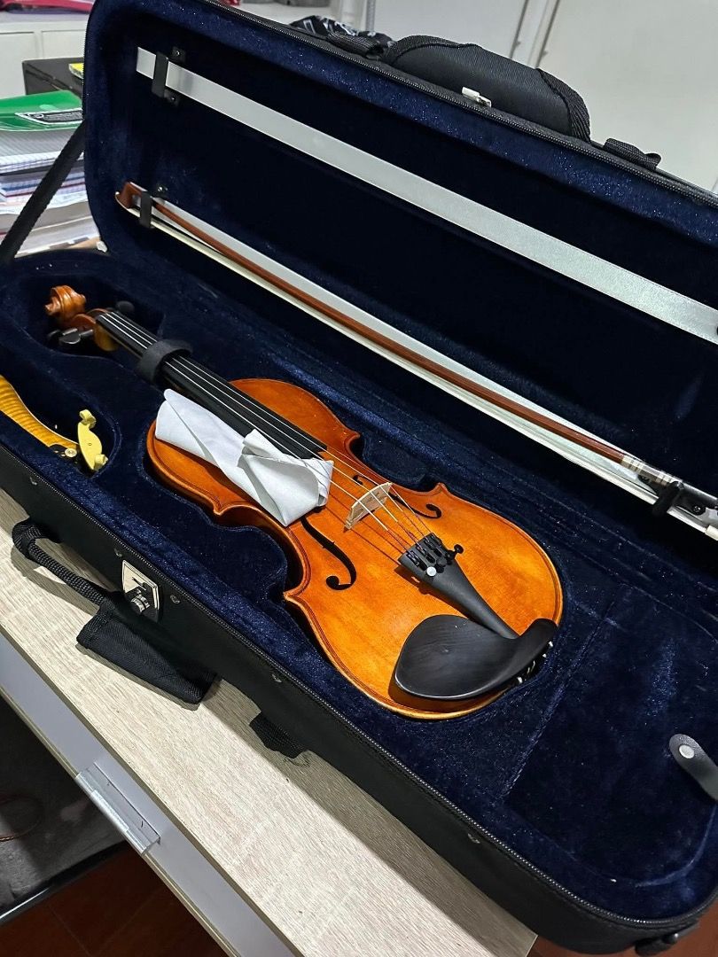 Violin with Bow and Case (Category: Musical Instruments) located in Malabon City. Submitted by malou1219 (Listing ID 1464276863, Image 2). Description: - Complete violin set: includes violin, bow, and hard case. - Violin features a beautiful wood finish. - Hard case interior is a stylish dark blue. - Perfect for beginner or intermediate players. - Ready to find a new home!.