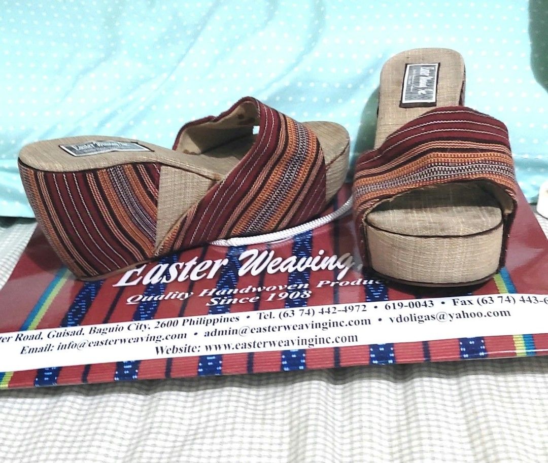 Wedge Slip-on (Category: Wedges) located in Paranaque City. Submitted by calm_youngstore7 (Listing ID 1464292763, Image 3). Description: Easter Weaving, Inc wedge slip-on Product Features Eastern Weaving wedge slip-on • Material: The upper straps and the wedge heel are covered in traditional Cordilleran handwoven fabric featuring vertical stripes of maroon, orange, white, and black. • Insole: The footbed is made of a breathable, natural woven can
