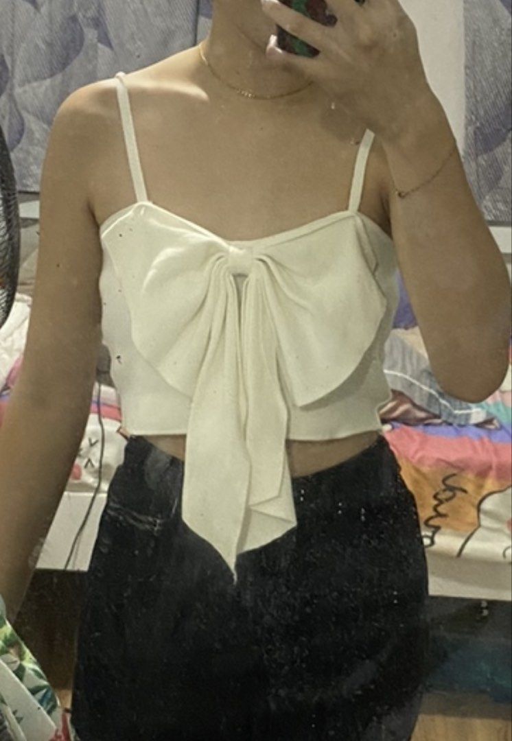 White Bow Crop Top with Spaghetti Straps (Category: Sleeveless) located in Quezon City. Submitted by kyjnll (Listing ID 1464271061, Image 2). Description: - Cute white crop top - Features a large bow detail at the front - Spaghetti straps - Versatile for casual or night out looks - Easy to style with high-waisted bottoms Project 4/Cubao area.