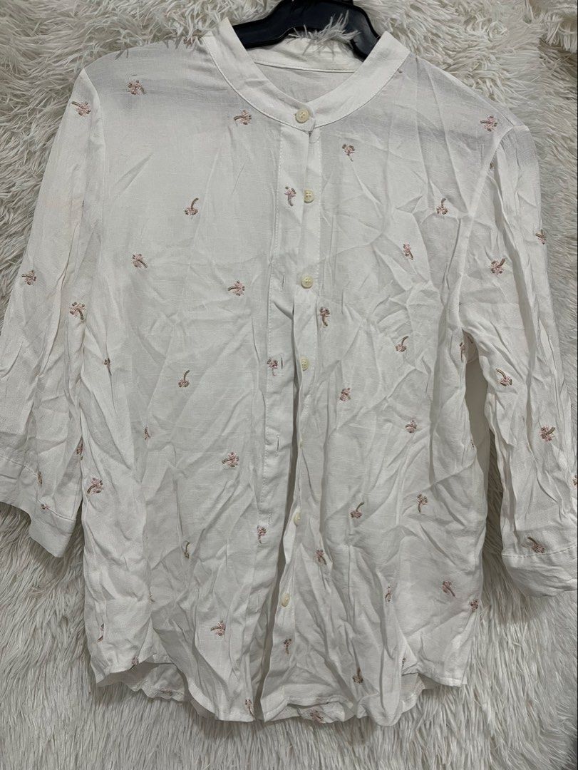 White Embroidered Button-Up Shirt (Category: Shirts) located in Imus. Submitted by nomsthriftshop (Listing ID 1464215908, Image 1). Description: - White button-up shirt - Delicate all-over embroidery - Mandarin collar with button closure - Three-quarter sleeves - Lightweight fabric - Perfect for casual styling.