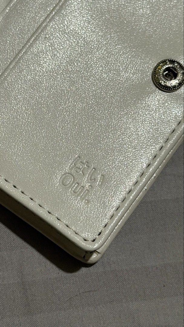 White Oui Wallet with Tote Bag (Category: Wallets & Card holders) located in Cavite. Submitted by noble_maybeblue (Listing ID 1464306134, Image 3). Description: - White wallet from Oui - Features card slots and a clear ID window - Comes with a reusable tote bag - Tote bag has Japanese text and 'Oui' print - Ideal for everyday use.