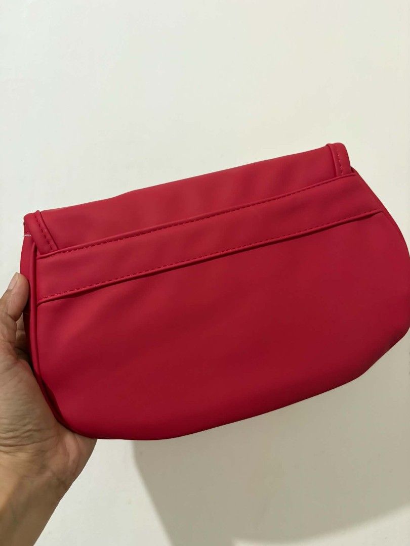 Witty Red Clutch Bag (Category: Clutches) located in Caloocan City. Submitted by vcsmartine20166 (Listing ID 1464256026, Image 2). Description: - Red clutch bag from Kittly - Magnetic snap closure - Simple and chic design - Ideal for casual outings or events - Ample space inside for essentials - Clean interior.