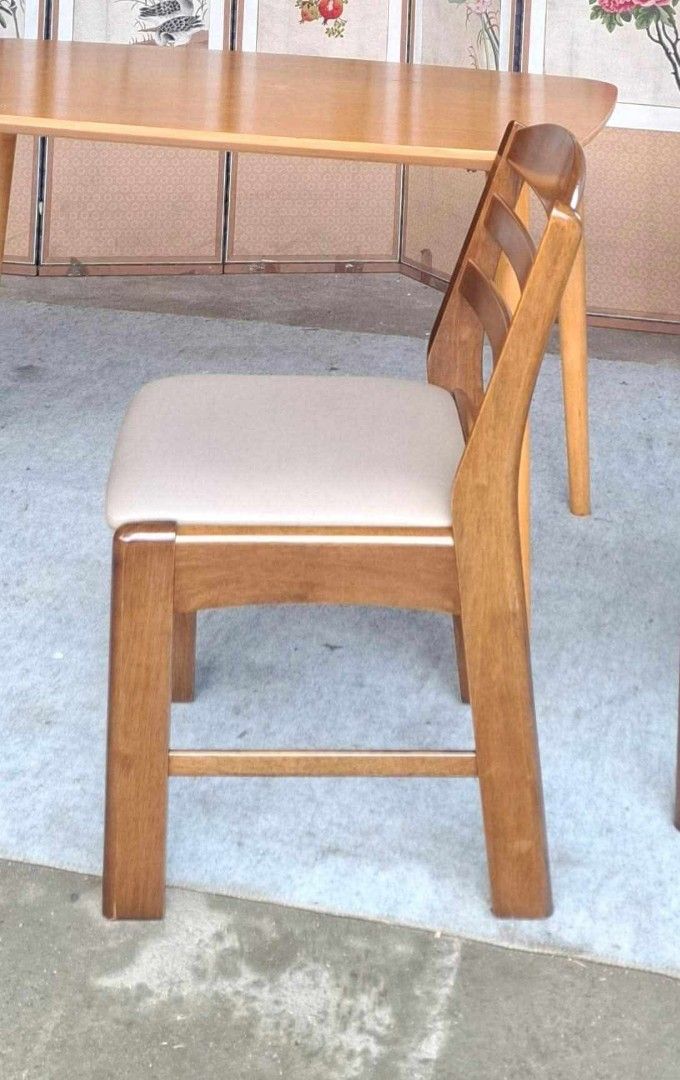 Wooden Dining Table and 4 Chairs Set (Category: Tables & Sets) located in Antipolo. Submitted by roselle001 (Listing ID 1464218654, Image 3). Description: - Light wood dining table with a smooth, rounded corner design. - Comes with 4 matching chairs in a darker wood finish. - Chairs feature comfortable light beige cushioned seats. - Elegant slatted back design on the chairs. - Angled table legs for a modern aesthetic. - Perfect for compact dining
