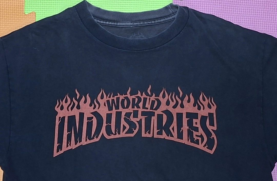 World Industries Flame Logo T-Shirt (Category: Tshirts & Polo Shirts ) located in Manila. Submitted by declutrredgoods (Listing ID 1464283606, Image 2). Description: - Classic black t-shirt - Features iconic World Industries flame logo - Shows some signs of wear, including a couple of small holes near the hem - Essential piece for streetwear enthusiasts.