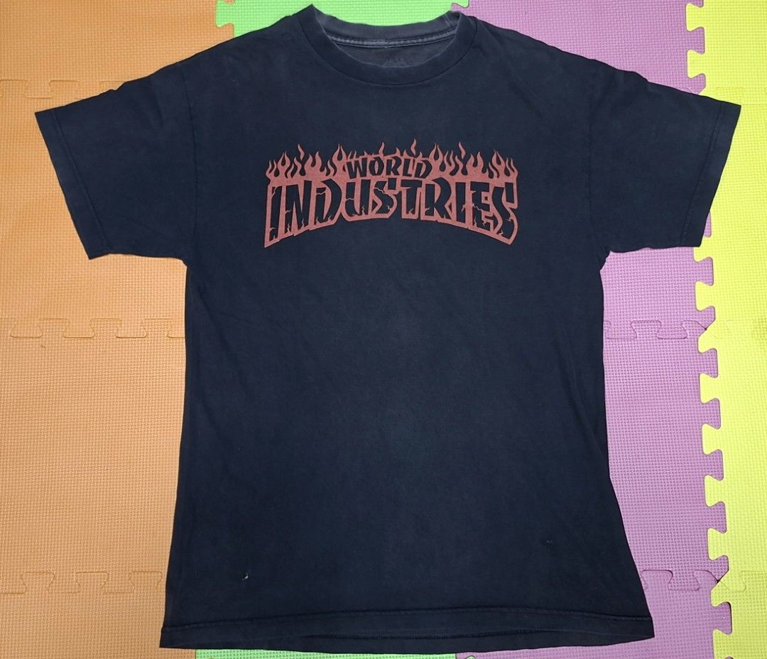 World Industries Flame Logo T-Shirt (Category: Tshirts & Polo Shirts ) located in Manila. Submitted by declutrredgoods (Listing ID 1464283606, Image 1). Description: - Classic black t-shirt - Features iconic World Industries flame logo - Shows some signs of wear, including a couple of small holes near the hem - Essential piece for streetwear enthusiasts.