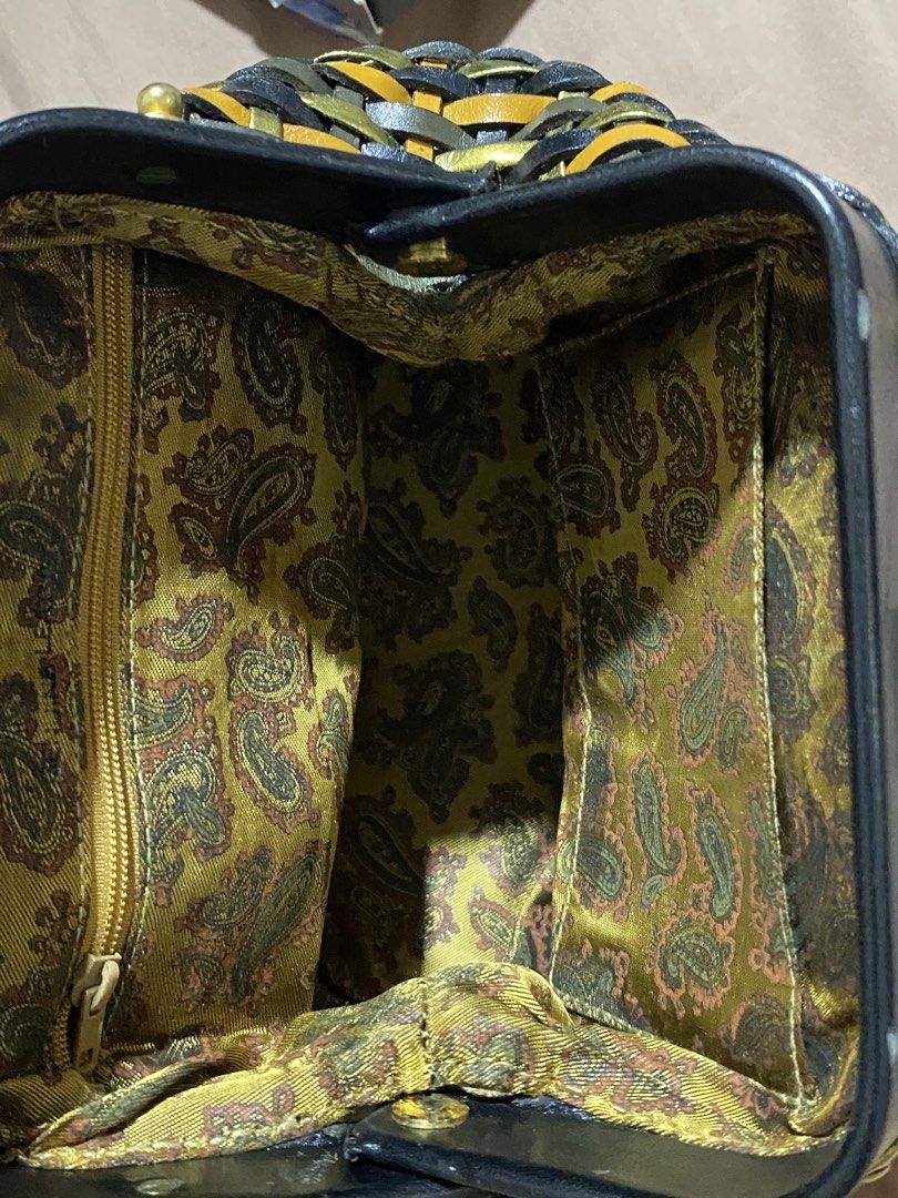 Woven Leather Handbag with Paisley Lining (Category: Shoulder Bags) located in Manila. Submitted by cdb_22 (Listing ID 1464190119, Image 3). Description: - Unique woven design with black, gold, and orange stripes. - Braided black leather top handles. - Detachable braided strap for versatile carrying. - Interior features a cool paisley pattern lining. - Includes an internal zippered pocket for essentials. - Secure closure with a black leather flap