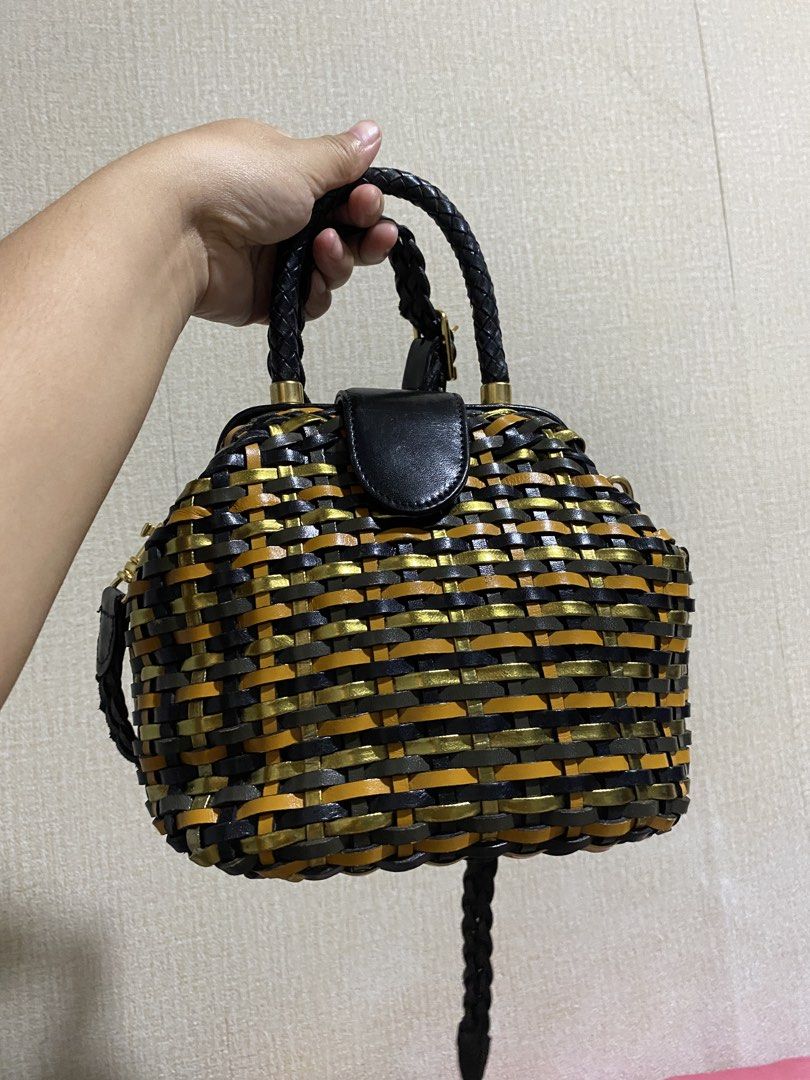 Woven Leather Handbag with Paisley Lining (Category: Shoulder Bags) located in Manila. Submitted by cdb_22 (Listing ID 1464190119, Image 1). Description: - Unique woven design with black, gold, and orange stripes. - Braided black leather top handles. - Detachable braided strap for versatile carrying. - Interior features a cool paisley pattern lining. - Includes an internal zippered pocket for essentials. - Secure closure with a black leather flap