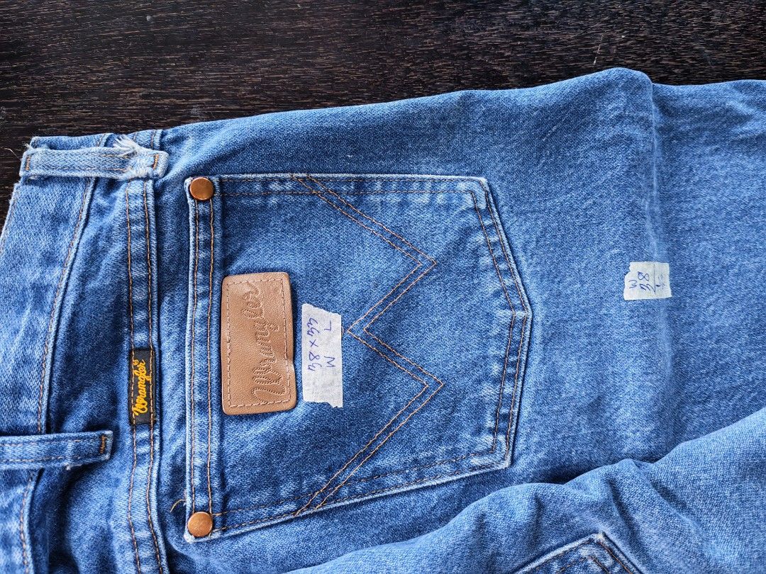 Wrangler Blue Denim Jeans (Category: Jeans) located in Baguio. Submitted by undressme24 (Listing ID 1464230445, Image 3). Description: - Classic blue denim jeans from Wrangler - Straight leg fit for a timeless silhouette - Secure button and zip closure - Convenient 5-pocket design (2 front, 2 back) - Iconic Wrangler logo patch on the back pocket - Versatile and durable, ideal for everyday wear.