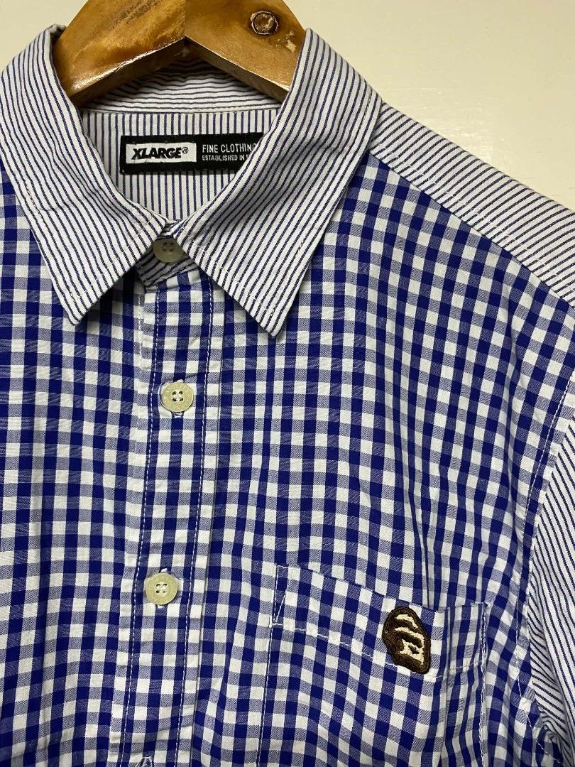 XLARGE Fine Clothing Button Up Shirt M Blue Gingham Stripe Patchwork (Category: Tshirts & Polo Shirts ) located in Pasig City. Submitted by jstnisidor81288 (Listing ID 1464235153, Image 3). Description: - XLARGE Button-Up Shirt - Blue gingham front - White pinstripe sleeves and back - Small ape head logo on chest pocket - Size: Medium (M) - Perfect for casual outfits.