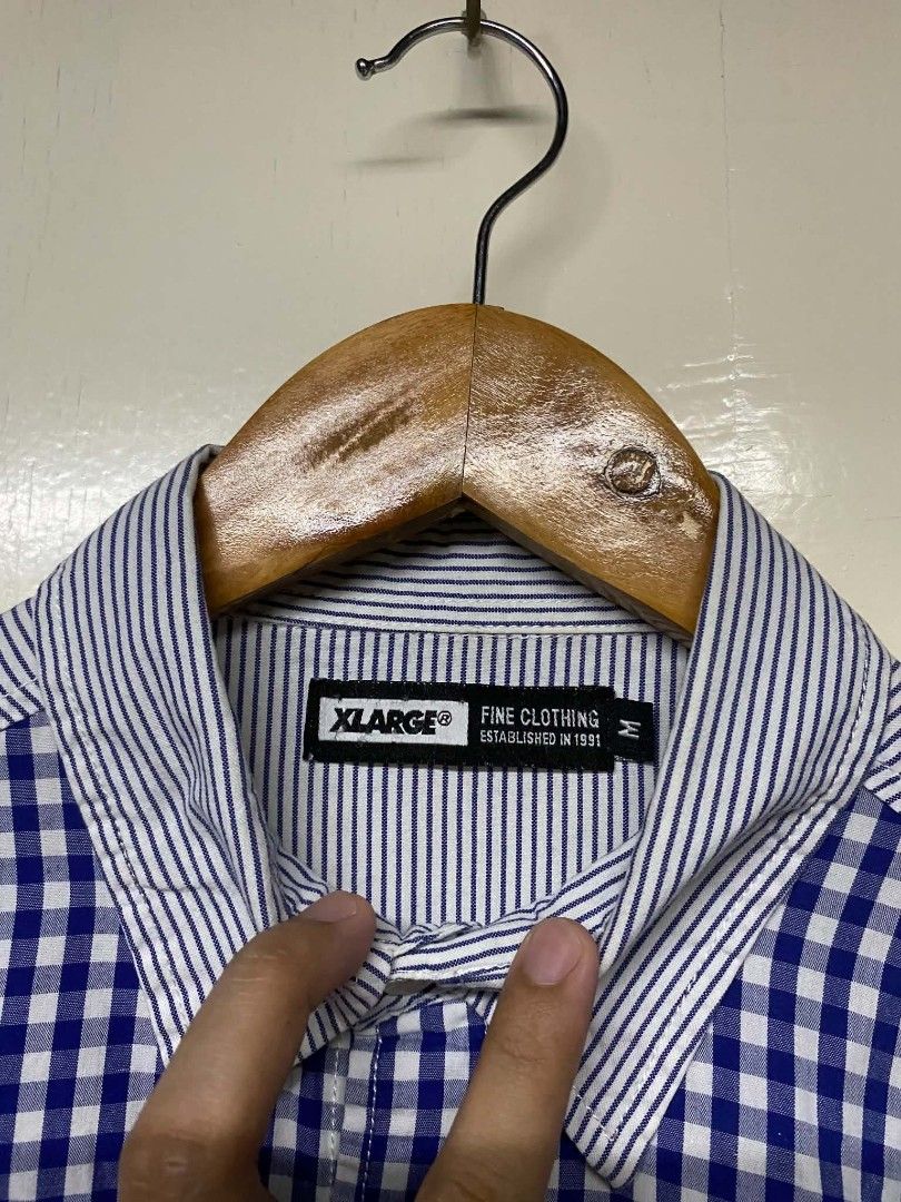 XLARGE Fine Clothing Button Up Shirt M Blue Gingham Stripe Patchwork (Category: Tshirts & Polo Shirts ) located in Pasig City. Submitted by jstnisidor81288 (Listing ID 1464235153, Image 2). Description: - XLARGE Button-Up Shirt - Blue gingham front - White pinstripe sleeves and back - Small ape head logo on chest pocket - Size: Medium (M) - Perfect for casual outfits.