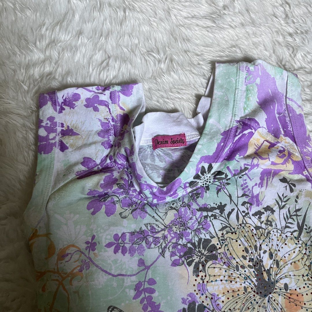 Y2k Floral Top (Category: Shirts) located in Maasin. Submitted by taraa18 (Listing ID 1464297661, Image 3). Description: - Adorable short-sleeved t-shirt - Features a vibrant floral and butterfly print - Colors: Light green, purple, and orange - Comfortable scoop neck design - Subtle sparkle details on the flowers for a touch of magic - Ideal for everyday casual wear.