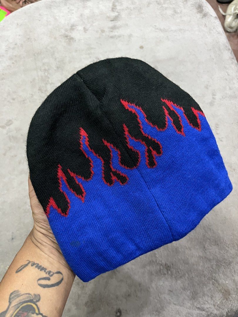 y2k-style flame knit beanie (Category: Beanies) located in General Trias. Submitted by zrchustle.604 (Listing ID 1464195242, Image 2). Description: y2k-style flame knit beanie, featuring a black crown with vibrant blue flames outlined in red. This classic design is highly popular in streetwear and vintage skate fashion..
