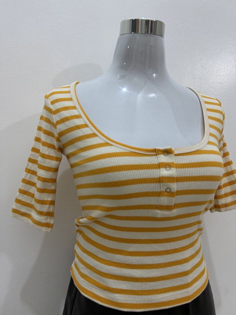 Yellow and White Striped Ribbed Henley Top (Category: Blouses) located in Manila. Submitted by e.louise (Listing ID 1464334775, Image 2). Description: - Cute ribbed top with yellow and white stripes - Features a scoop neckline and short sleeves - Button-up detail at the front - Versatile for pairing with jeans or skirts - Comfortable and stylish for everyday wear.